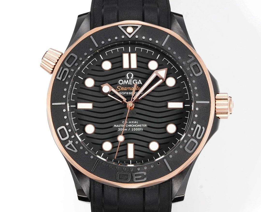 Front view of black rubber diver watch with rose-gold bezel, black dial, and gold-tone hands.
