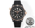 Black rubber diver watch with rose-gold bezel and dial, round stainless-steel case.