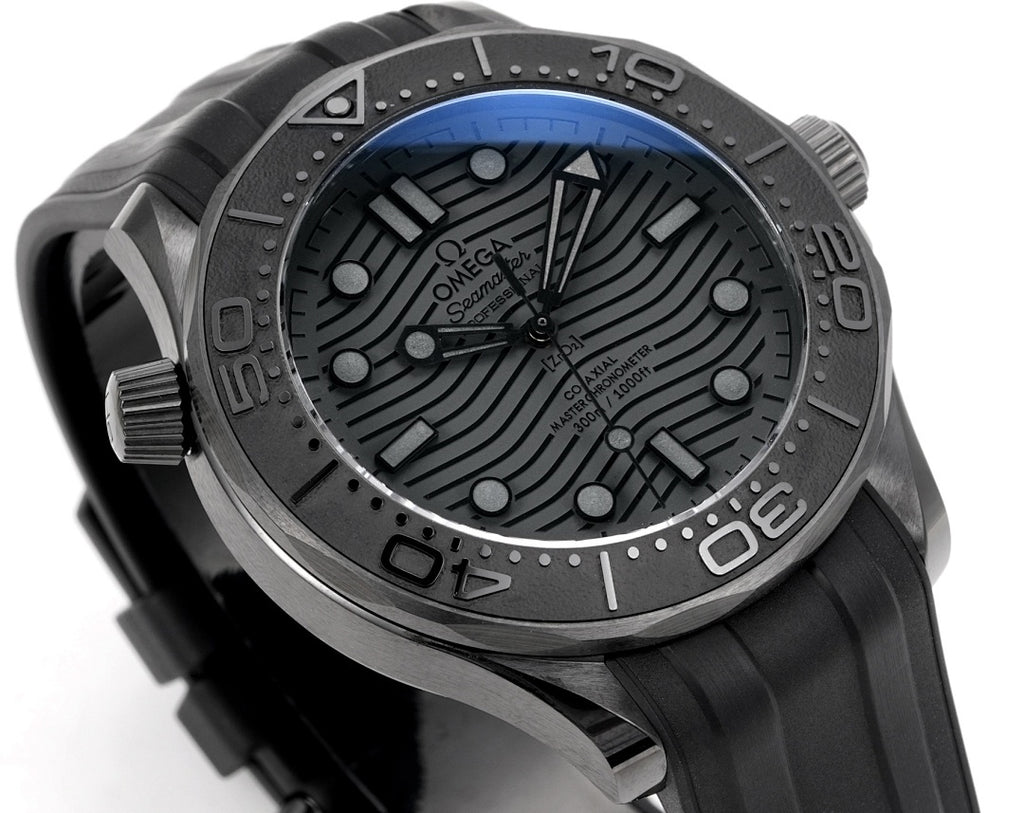 Omega Seamaster watch dial angled view with black textured pattern and metal hands.