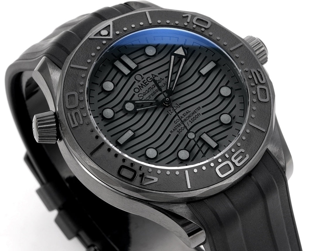 Omega Seamaster watch dial angled view with black textured pattern and metal hands.