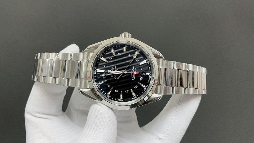 Steel bracelet wristwatch with dark dial, luminous markers, and gold-tipped accents