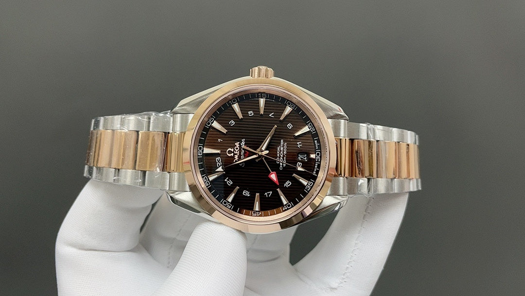 Rose-gold bezel two-tone wristwatch with dark dial and three hands on bracelet