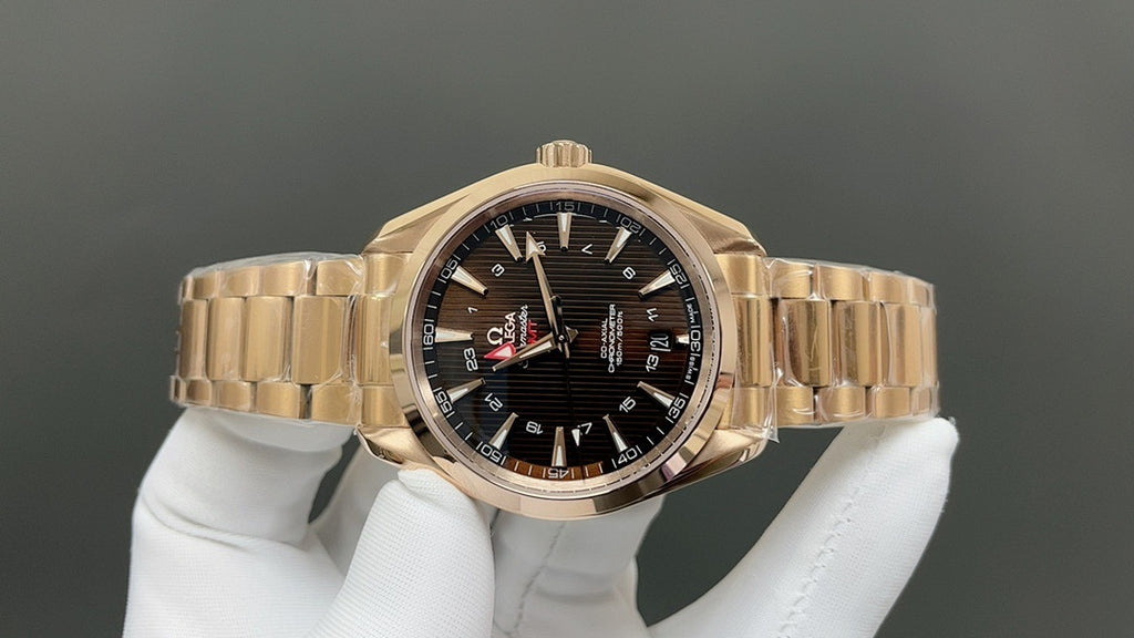 Gold wristwatch with black dial, baton hour markers and red seconds hand