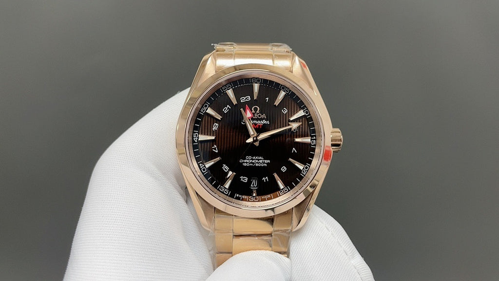 Gold Omega wristwatch with black dial, multiple subdials and metal link band