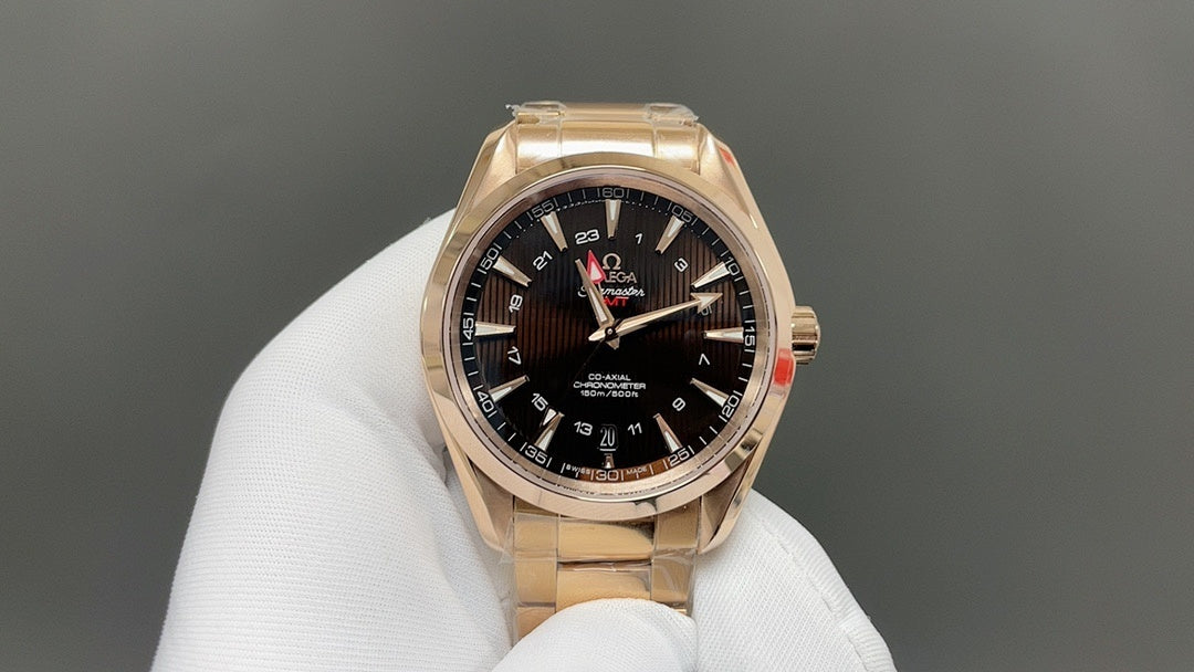 Gold Omega wristwatch with black dial, multiple subdials and metal link band