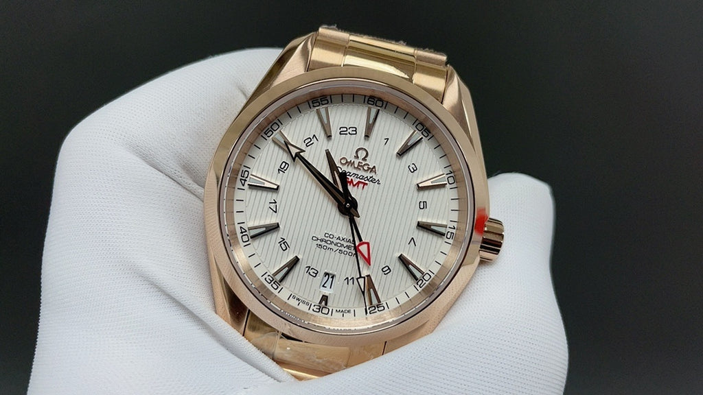 Gold wristwatch with white dial, black hands and red seconds hand