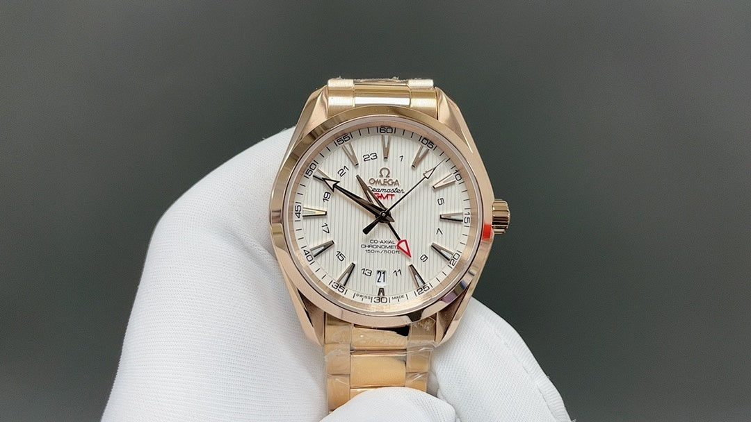 Omega watch with gold case and white dial, metal bracelet on display