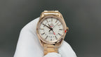 Omega watch with gold metal bracelet and white dial, chronograph-style subdials