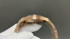 Gold wristwatch top view, polished case and crown with metal link band