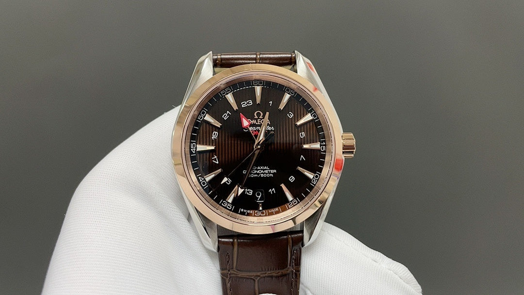 Analog wristwatch with black dial and gold-tone case, brown leather strap