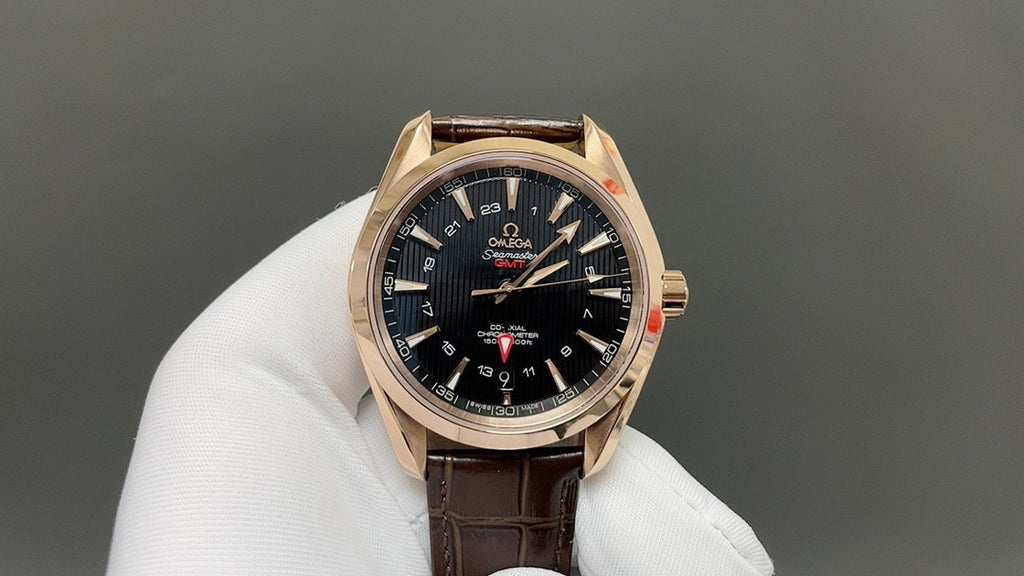 Analog wristwatch with black dial, gold-tone bezel, and brown leather strap