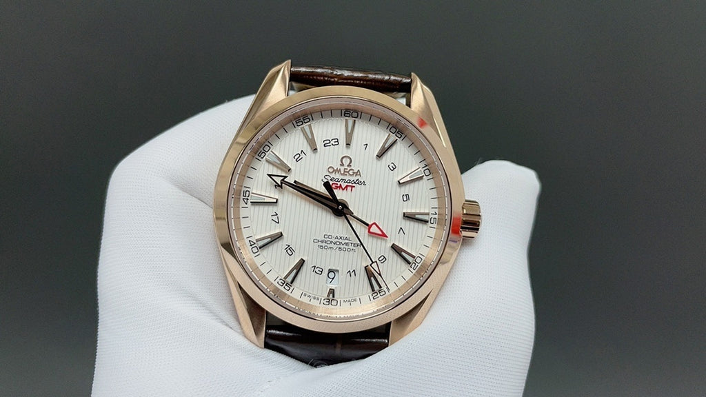 Analog wristwatch with gold-tone case, white dial, and brown leather strap