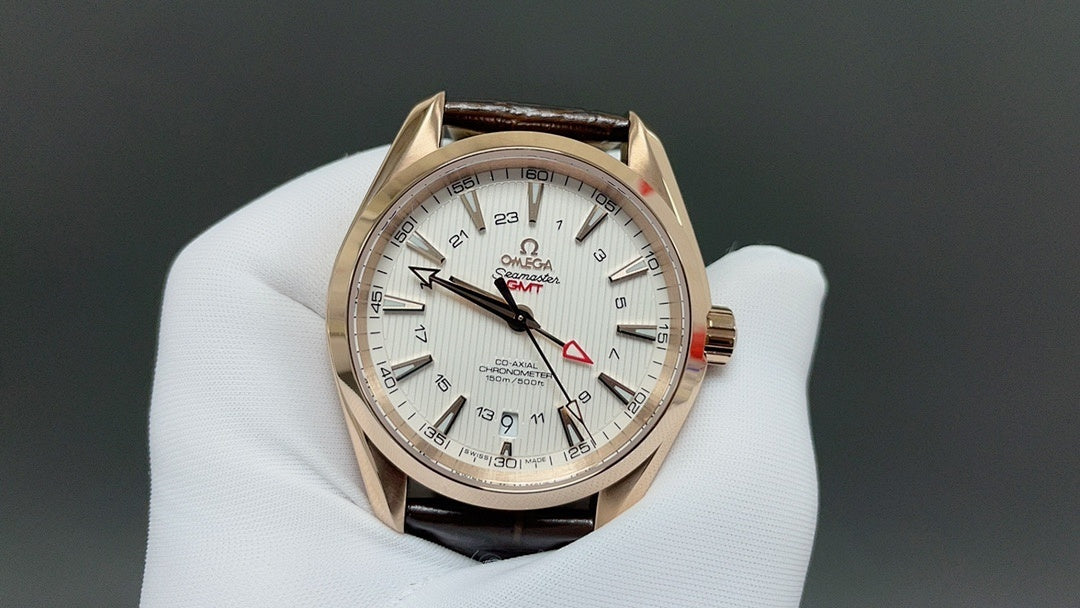 Analog wristwatch with gold-tone case, white dial, and brown leather strap