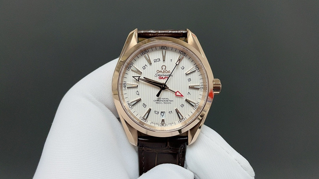 Analog wristwatch with gold-tone case, white dial, and brown leather strap