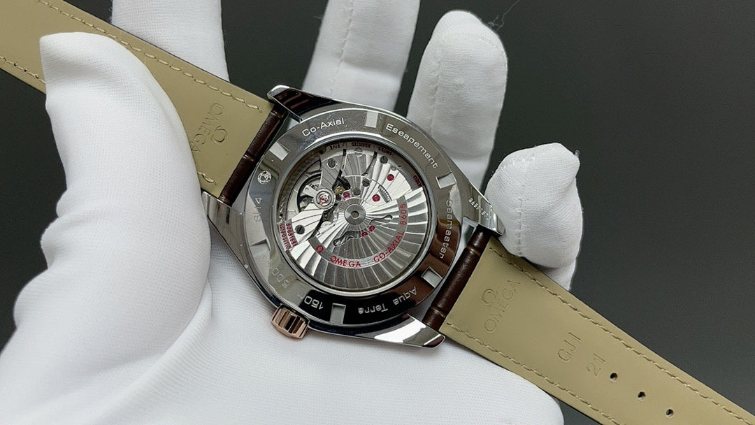 Analog wristwatch with open caseback, visible movement, and brown leather strap