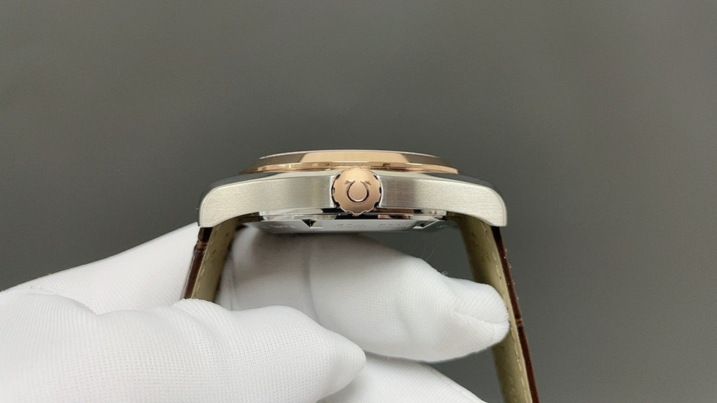 Omega watch with gold-tone case and crown, side view