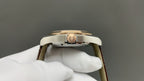 Omega watch with gold-tone case and crown, side view