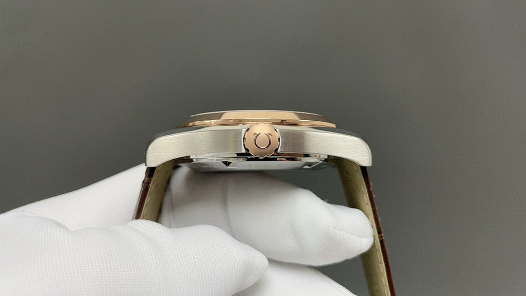 Omega watch with gold-tone case and crown, side view
