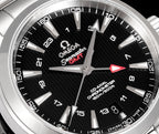 Black dial close-up with red arrow seconds hand and silver hour markers