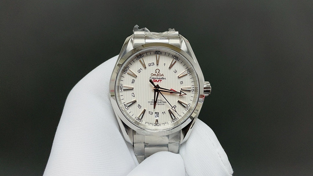 Omega watch with silver bracelet and white dial, red and black GMT-style markings