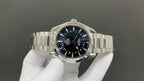 Omega watch with dark blue dial, silver bracelet, and red-tipped seconds hand