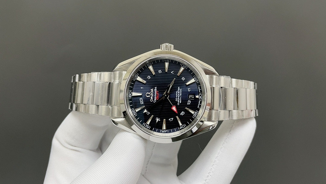 Omega watch with dark blue dial, silver bracelet, and red-tipped seconds hand