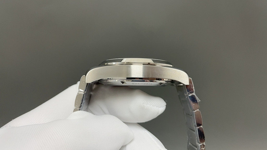 Omega watch caseback close-up with polished silver metal back and crown