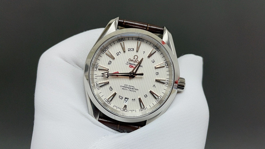 Omega watch with white dial, silver case, and brown leather strap
