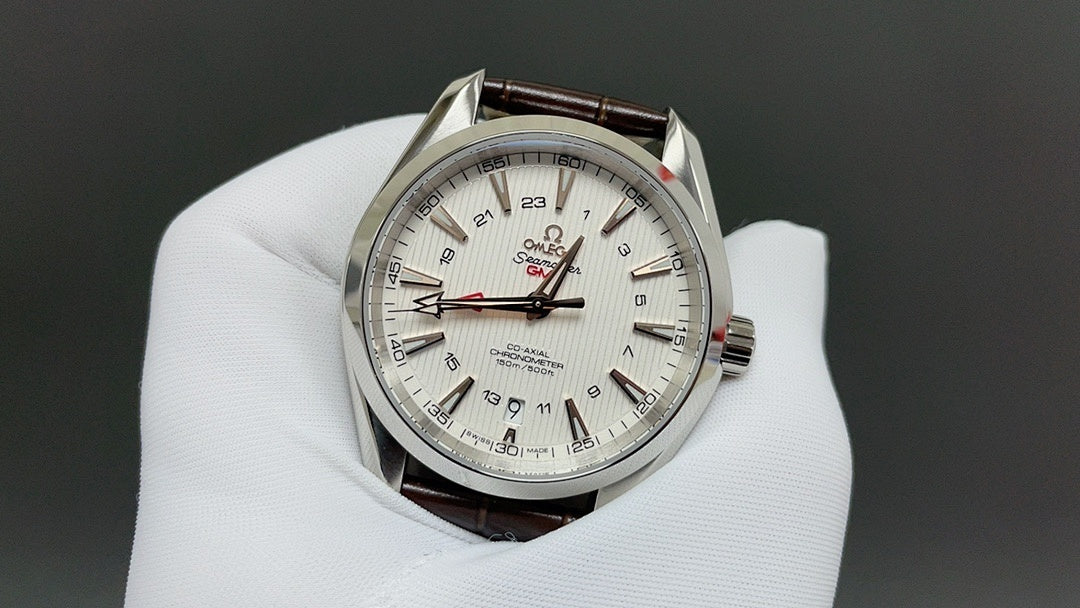 Omega watch with white dial, silver case, and brown leather strap