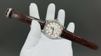 Omega watch with white dial and brown leather strap