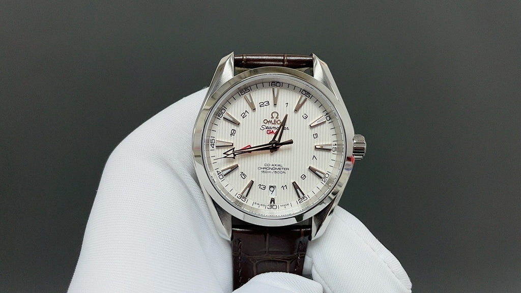 Omega watch front with white dial, markers, and brown leather strap