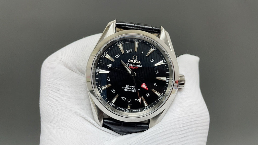 Omega watch with black dial and blue hour markers, silver bezel, black leather strap