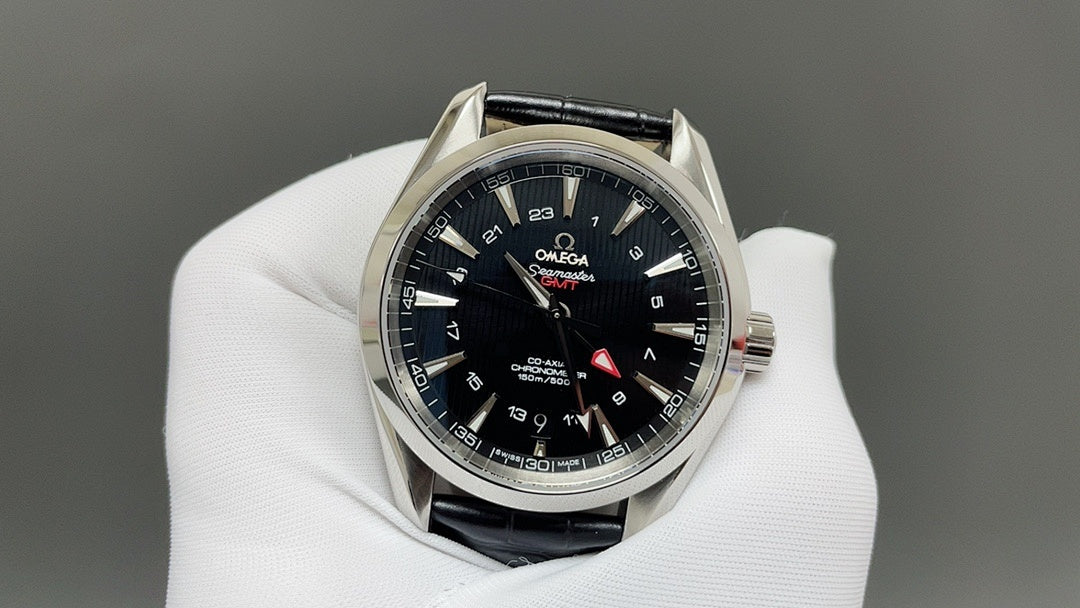 Omega watch with black dial and blue hour markers, silver bezel, black leather strap