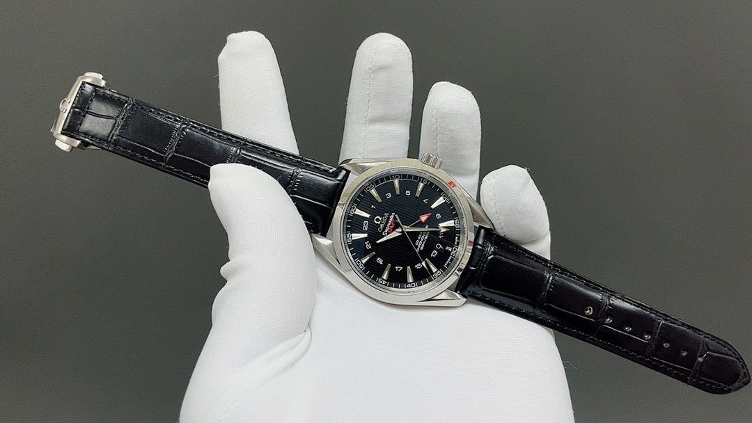Omega watch with dark dial and black leather strap, crown visible