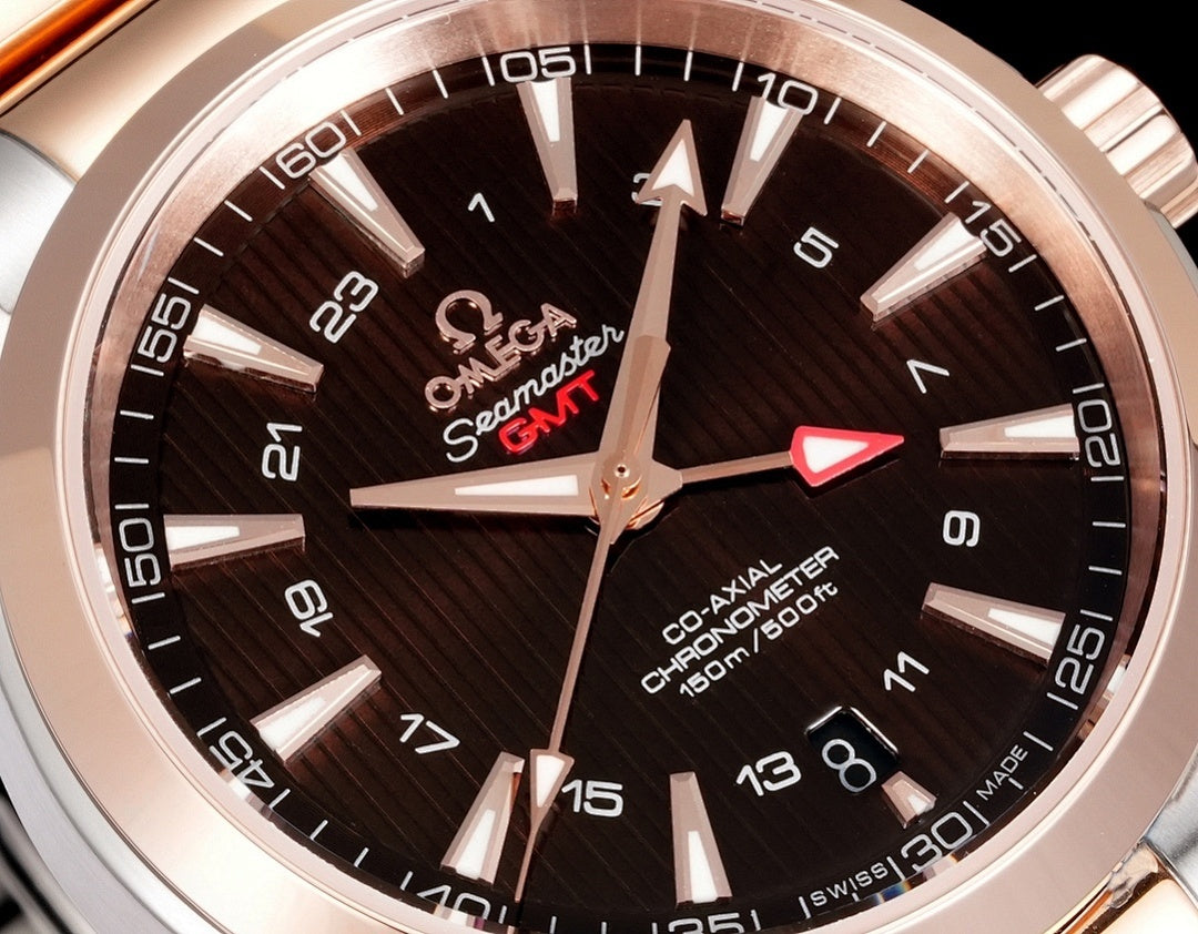 Omega Seamaster GMT watch dial close-up with dark face and rose-gold markers