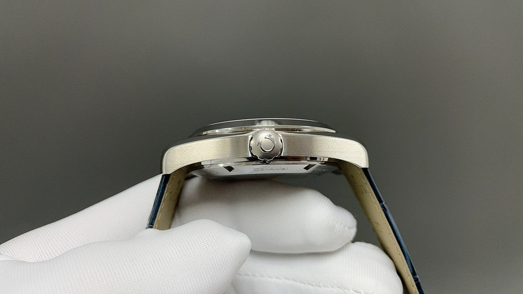 Wristwatch case back view with screw-down center and blue strap