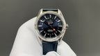 Wristwatch with dark blue dial and blue leather strap, silver bezel and date ring