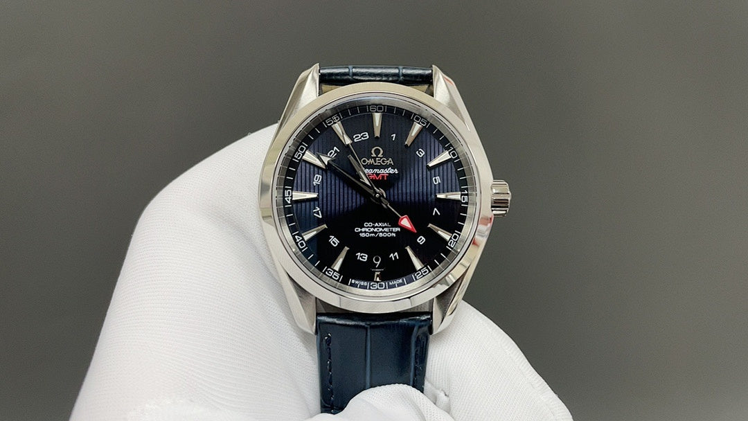 Wristwatch with dark blue dial and blue leather strap, silver bezel and date ring