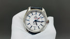 Wristwatch with white dial and blue leather strap, silver case and red accents
