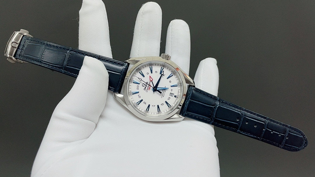 Wristwatch on blue leather strap held in gloves, white dial with red details