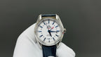 Wristwatch with white dial, blue leather strap, silver case, three hands and markers
