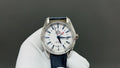 Wristwatch with white dial, blue leather strap, silver case and baton hour markers