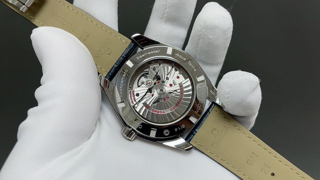 Wristwatch with exposed dial and blue leather strap, silver case back and lugs