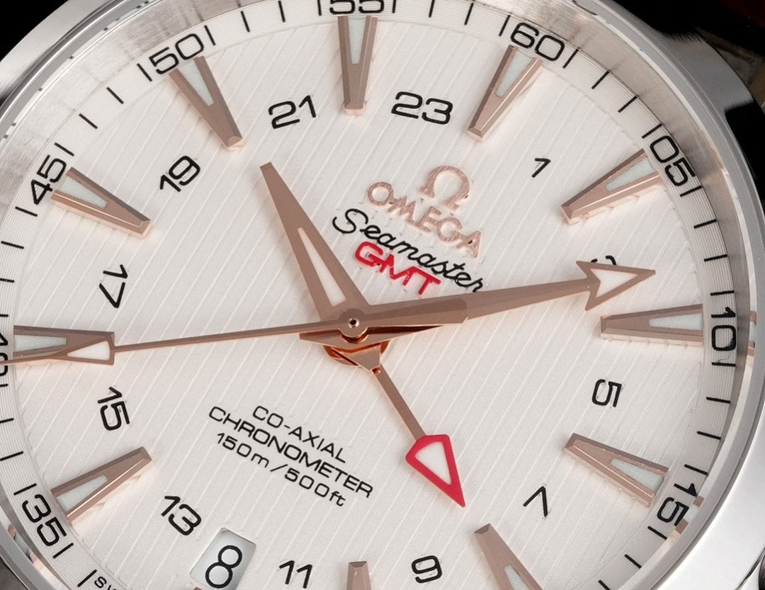 Omega Seamaster watch close-up, white dial with gold-tone hands and hour markers.