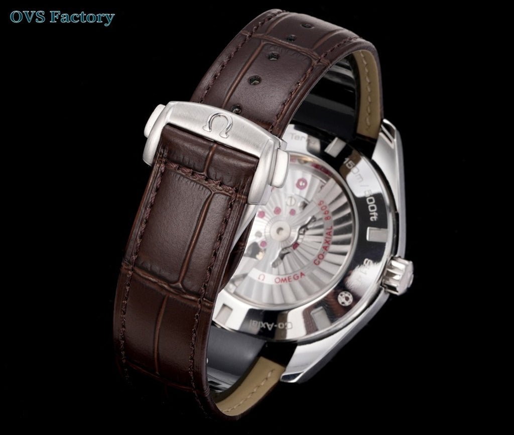 Omega Seamaster watch, white dial with visible movement, brown leather strap, silver case.