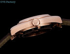 Omega wristwatch rose-gold caseback with crown and dark leather strap.