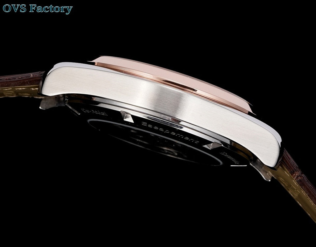 Steel wristwatch case with rose-gold bezel detail and leather strap, side profile
