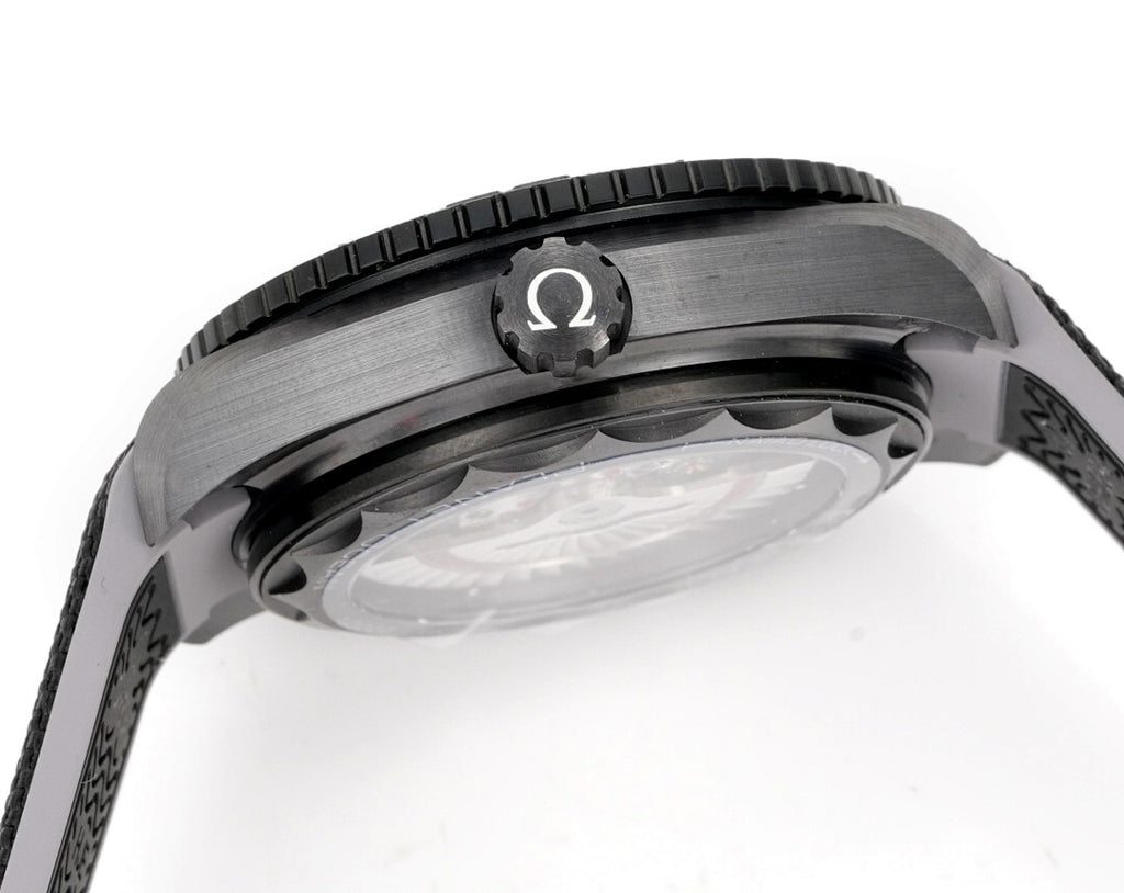 Omega watch close-up showing bezel and Ω marker above the crystal