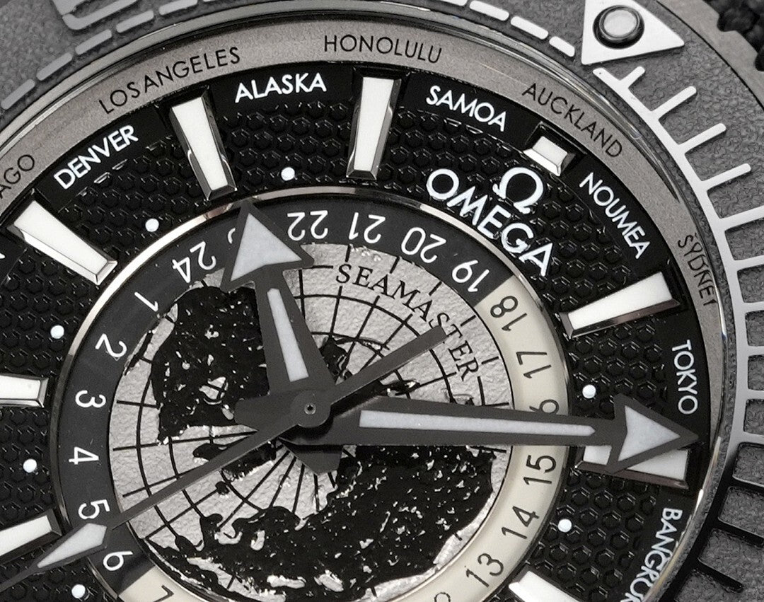 Omega watch dial close-up with world-time ring markings and black subdials