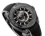 Omega watch dial close-up with world-time ring and black fabric strap